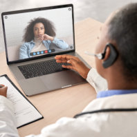 A doctor talking to his patient through a video call
