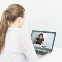 A woman talking to another person through a video call