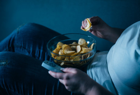 A person eating unhealthy foods