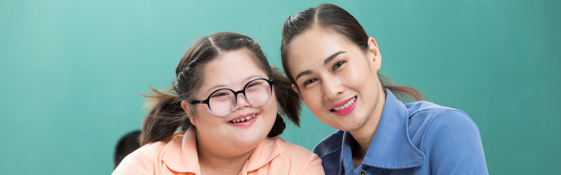 A child and a female smiling together