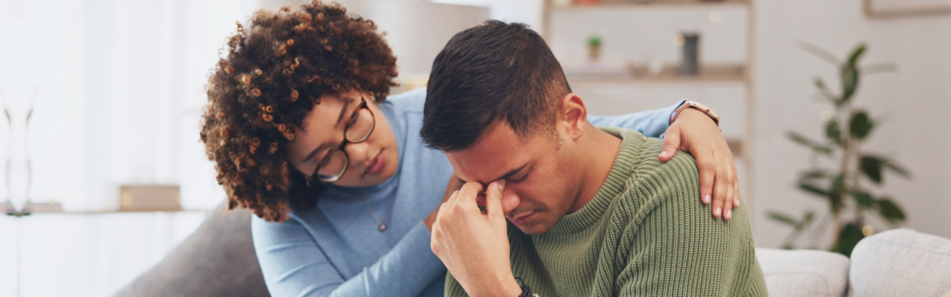 A female psychiatrist comforting a man having problems