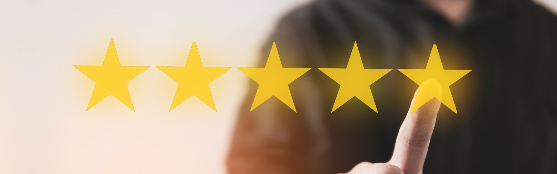 A person pointing at a five star showing a satisfaction rating