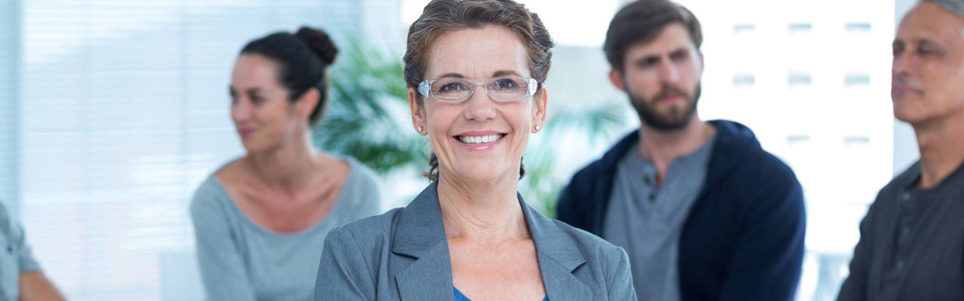 A professional woman smiling in front of a group